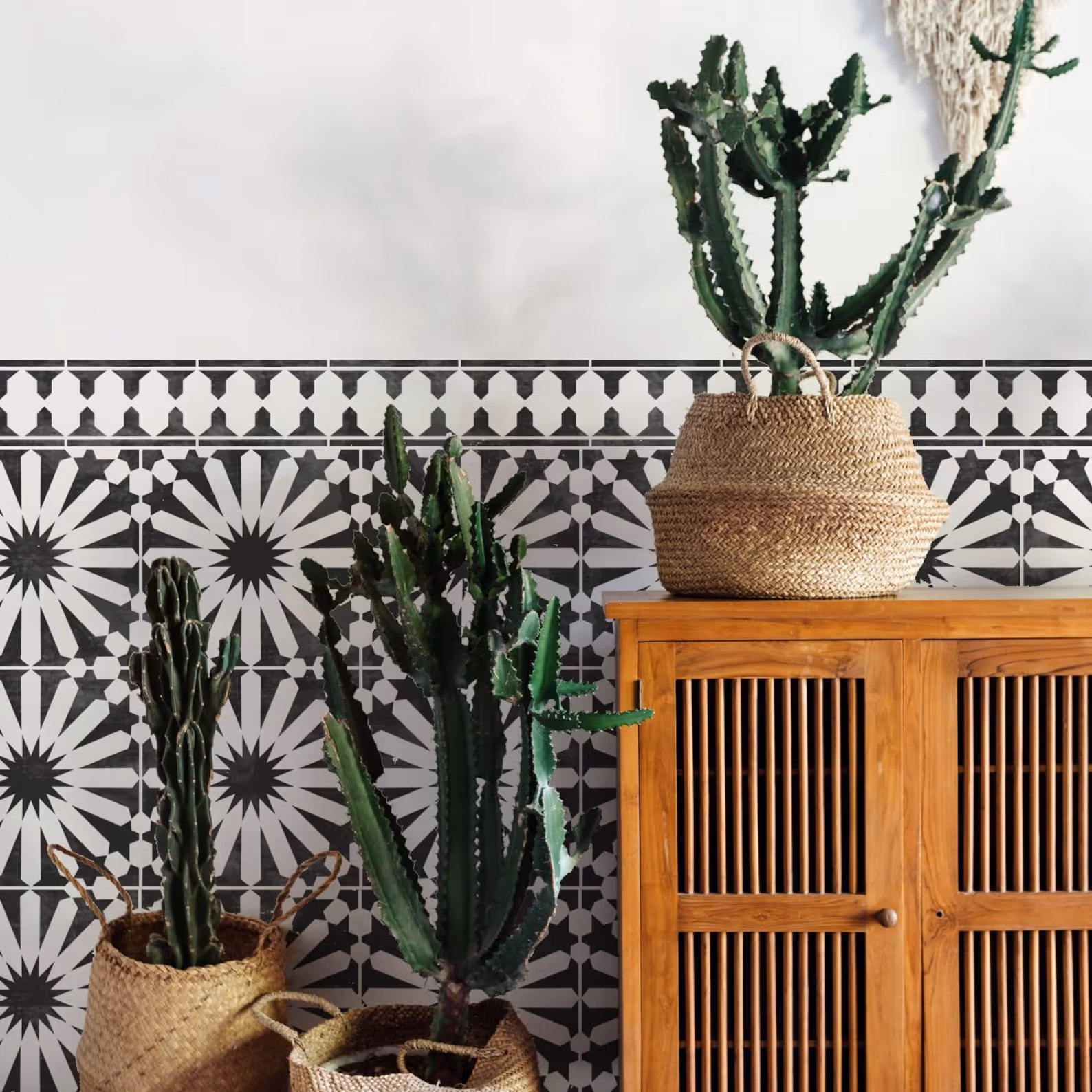 A white painted wall stencilled in a black moroccan tile design.