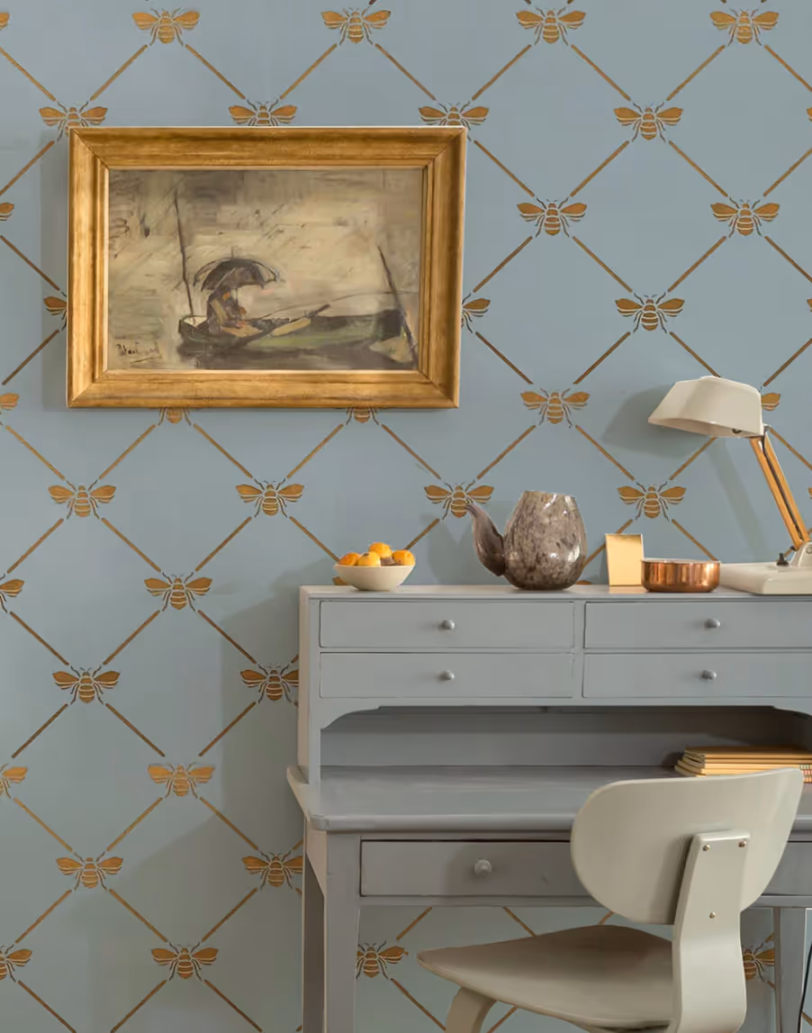 Elegant bee trellis design stencilled in gold on a duck egg painted wall. 