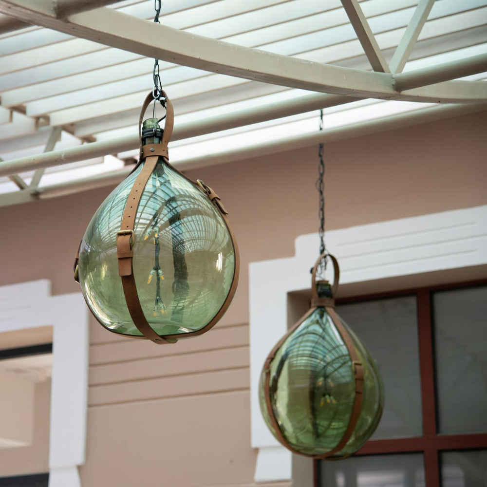 Pendant lights made from green glass terrariums.