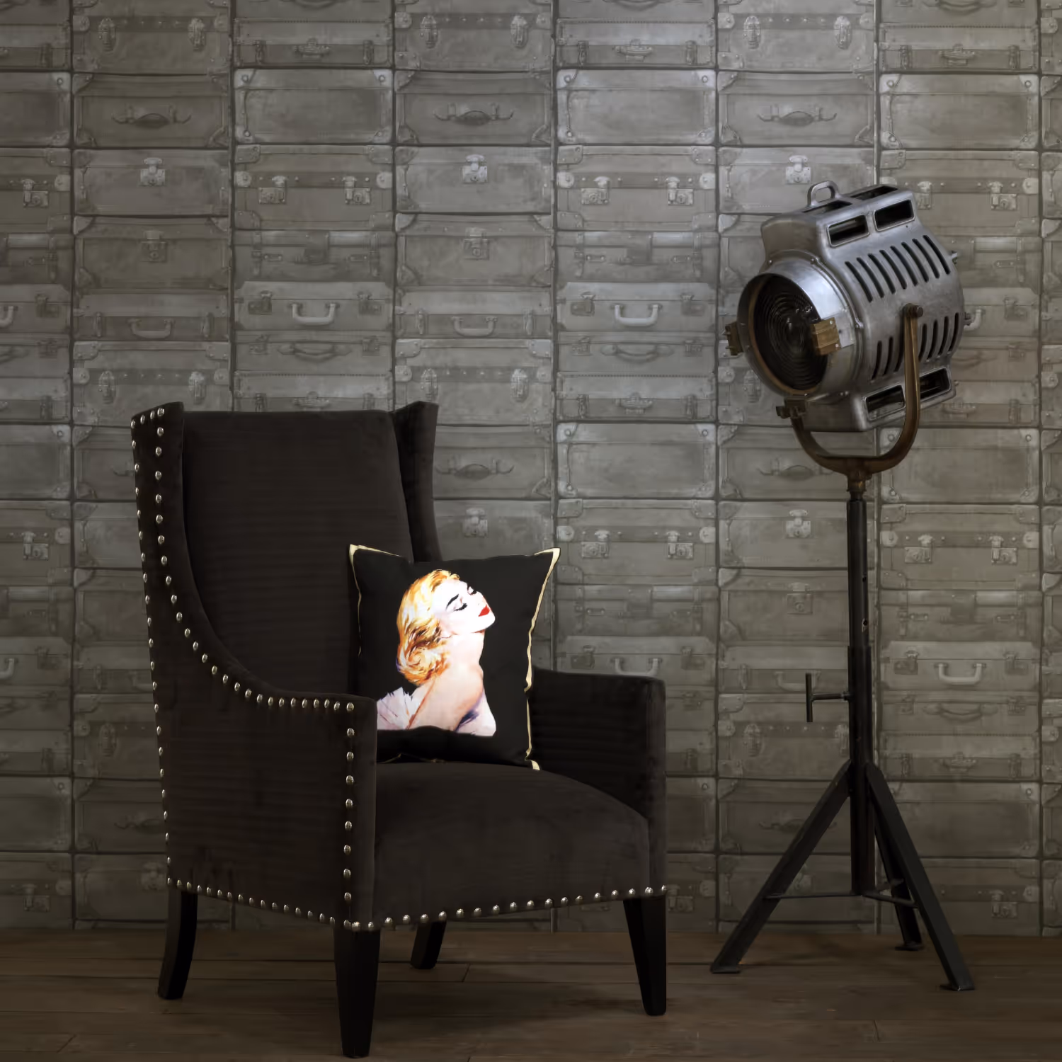 An elegant black chair in front of a wall with a luggage themed wallcovering