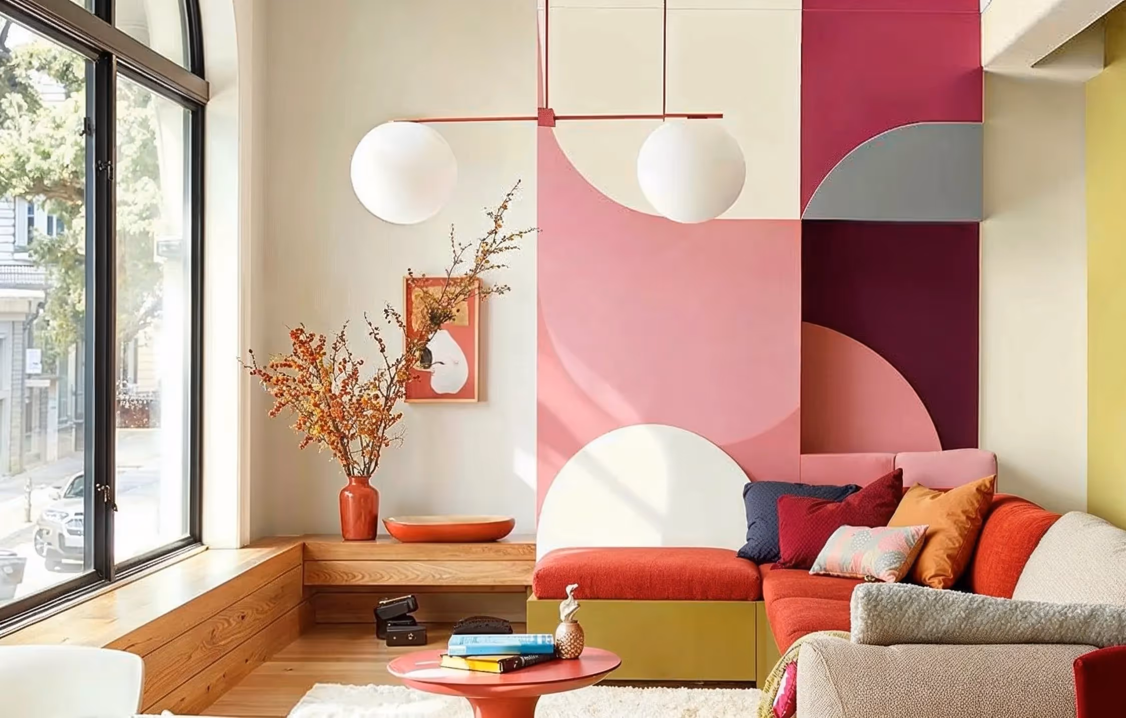 A modern living room with multicoloured shaped of block colour on the walls
