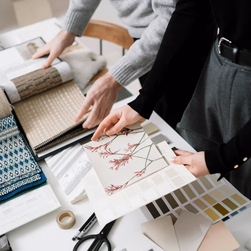 An interior designer showing paint and wallpaper samples to a client