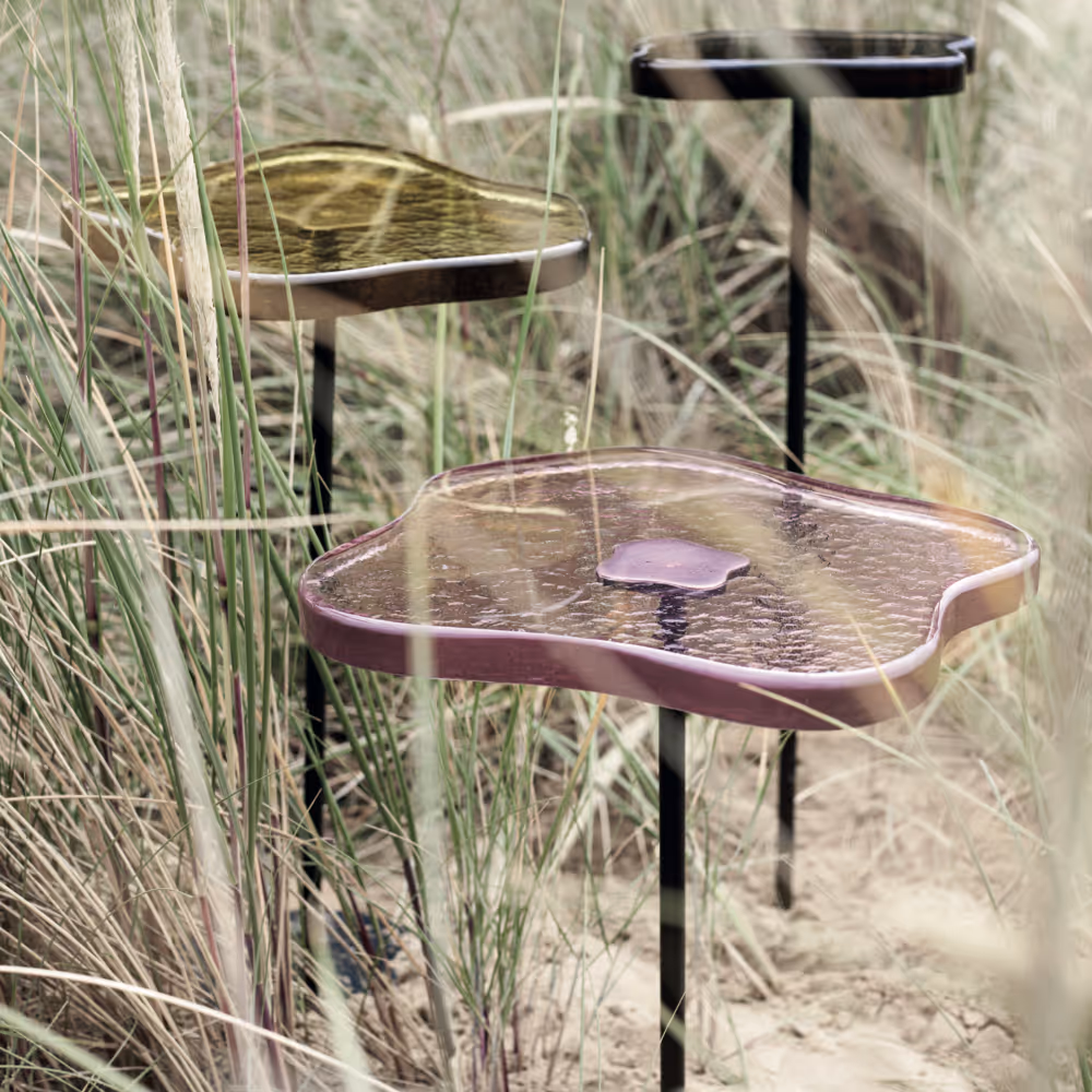 Handmade side tables made from coloured glass and iron.